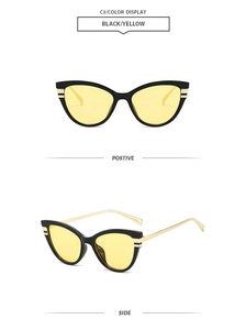 Detail view of cat eye sunglasses featuring black frames with yellow lenses and gold arms