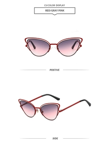 Detail view of red butterfly cat-eye sunglasses with gradient pink lenses and hollow frame