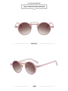 Macro shot of jelly pink double bridge round sunglasses with gradient brown lenses