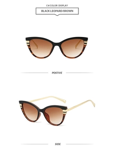 Detail of cat eye sunglasses with black leopard frame and gold metal temples