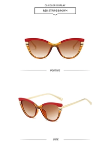 Retro cat-eye sunglasses with red striped frame, brown lenses, and gold metal temples