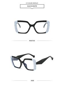 Macro view of square frame sunglasses with blue color-blocking and rhinestone accents