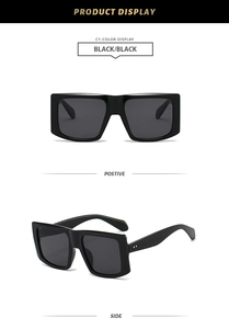 Detail view of black chunky square sunglasses with thick frames and dark lenses