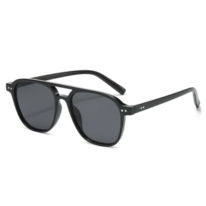 Classic black pilot sunglasses with double bridge and silver rivet accents on white background