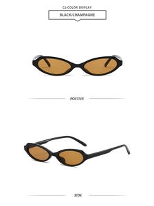 Detail view of vintage cat-eye sunglasses with black frames and champagne lenses