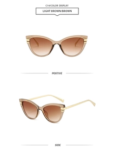 Detail view of vintage cat-eye sunglasses with champagne gold frames and brown gradient lenses