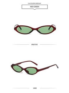 Detail view of oval retro cat-eye sunglasses in dark red frame with green lenses