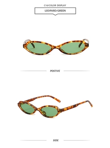 Detail view of vintage cat eye sunglasses in leopard frame with green lenses