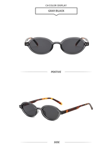 Viste dettagliate di occhiali da sole ovali vintage grigio nero con aste tartaruga