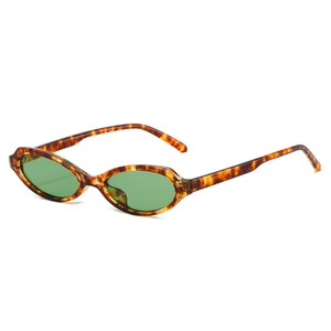 Retro tortoise shell oval sunglasses with green lenses and vintage Y2K 90s aesthetic