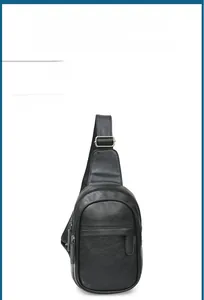 Detail of black PU leather chest bag with lychee texture and metallic zipper buckle