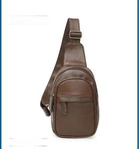 Detail of dark brown leather sling bag featuring lychee texture and silver metal hardware
