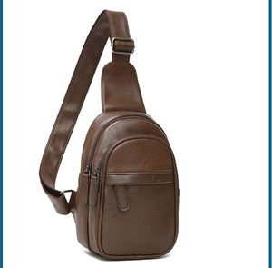 Detail view of deep brown men's sling bag with premium lychee pattern and double zippers