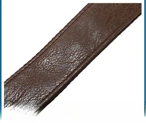 Detail of reinforced double-layer leather shoulder strap with neat stitching and litchi grain