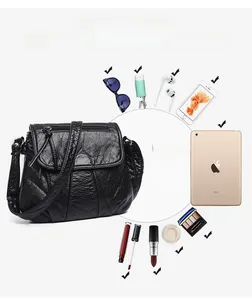 Macro view of large-capacity black PU leather bag showing daily items like an iPad mini