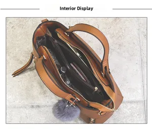 Interior view of brown tote bag showing multi-compartment lining and gold hardware details