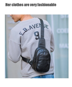 Close-up of black PU leather sling bag with metal zippers shown on a male model