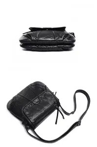 Detail view of black pleated PU leather crossbody bag with dual zipper compartments