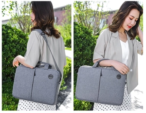 Close-up of light gray laptop bag featuring adjustable straps and dual handles for travel