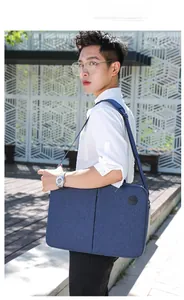 Navy blue multi-functional 15-inch laptop bag with wide shoulder strap for business commute