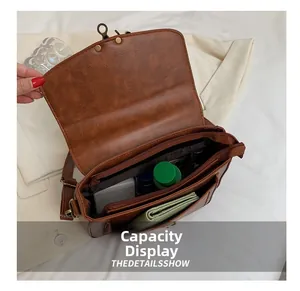 Detailed interior view of vintage brown PU leather handbag showing multiple compartments