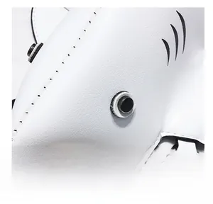 Detail of shark-shaped white leather bag showing matte black hardware eye and fine stitching