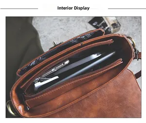 Internal view of brown vintage PU leather bag showing multi-layer zipper compartments