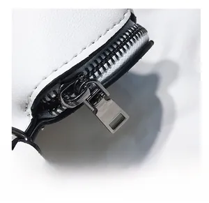Close-up of smooth gunmetal zipper and precise stitching on white leather shark bag