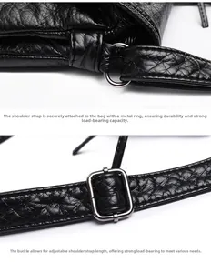 Close-up of durable silver metal rings and adjustable buckle on black washed PU leather bag