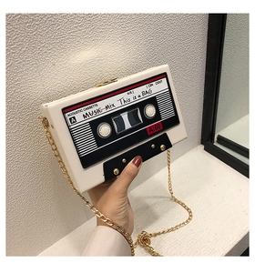 Close-up of vintage cassette tape crossbody bag with a gold chain strap and metal clasp