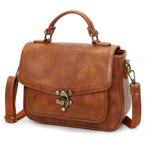 Close-up of brown PU leather bag showing vintage bronze twist lock and neat stitching detail