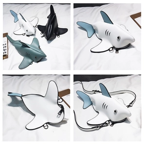 Detail view of mini shark crossbody bags in black, white and blue grey PU leather