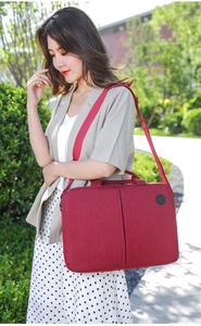 Red laptop bag for 15-inch notebooks with textured fabric and comfortable shoulder strap