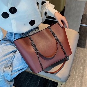 Deep brown oversized matte faux leather tote bag with metal chain strap detail