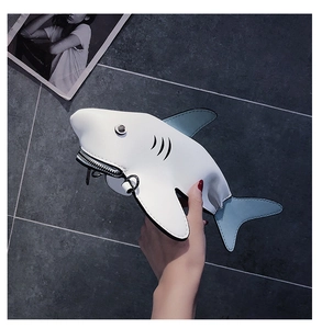 Detail of creative shark mini bag featuring bicolored synthetic leather and metal zipper