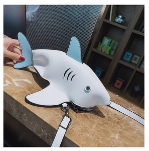 Close-up of shark shaped mini crossbody bag in white and sky blue leather