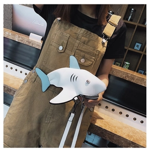 On-model shot of a creative shark-shaped PU leather crossbody bag in white and blue