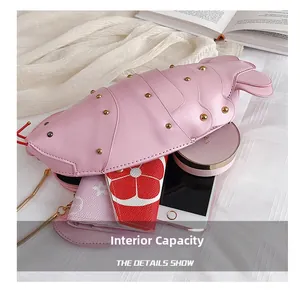 Internal capacity of the pink lobster shaped crossbody bag showing space for phone and wallet