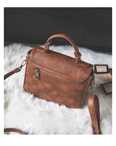 Detailed view of the brown PU leather vintage handbag with bronze hardware and stitching