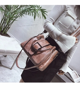 Detail of vintage brown matte leather lady bag with metal buckle and wide strap