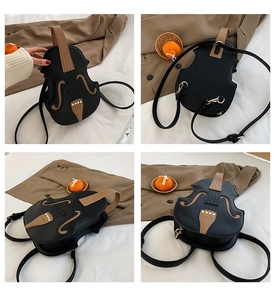 Detail view of the violin-shaped crossbody bag with realistic f-holes and adjustable straps