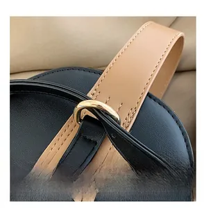 Detailed macro view of premium leather stitching and golden metal hardware on the handbag