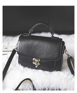 Close-up of vintage black PU leather square bag with textured finish and antique metal lock
