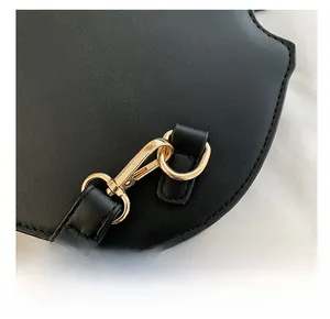 Close-up of golden metal hook and precision stitching on the black leather violin bag