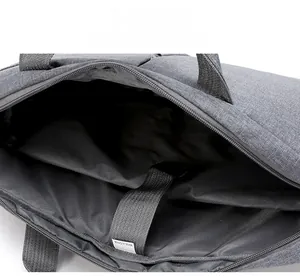 Detail view of the gray laptop bag interior featuring a sturdy zipper and durable lining