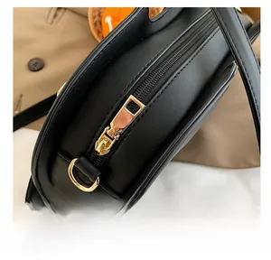 Detail view of the smooth golden metal zipper and hardware on this black violin bag