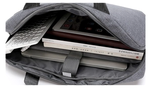 Internal view of a grey fabric laptop case with padded compartments and elastic straps