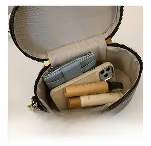 Top view of quilted bucket bag interior showing spacious grey lining and daily items
