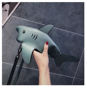 Detail of shark-shaped mini crossbody bag showing PU leather texture and zip closure
