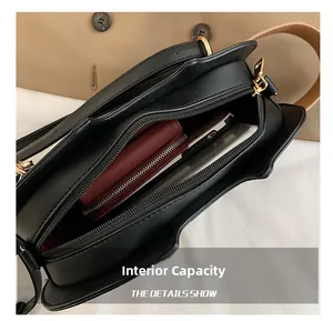 Internal view of black crossbody bag showing smartphone and long wallet storage